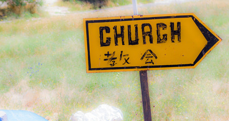 Sign for a Christian church in Turkey, abstract background, in English and in Chinese