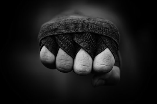 Beautiful black and white image of a male fist in boxing bandages