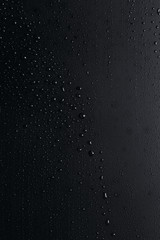 Water drops on a rough black surface