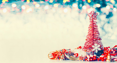 Christmas banner background with red tree, star and festive decoration on blue winter bokeh , front view