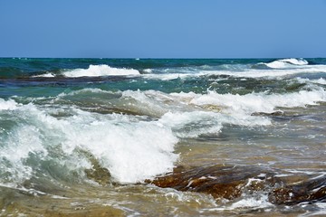 Beautiful clean sea and waves. Summer background for travel and holidays. Greece Crete.. Amazing scenery on the beach.