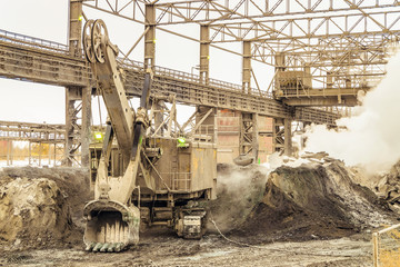 Big bucket mining excavator on a crawler in outdoors plant shop. Excavator with mechanical drive...