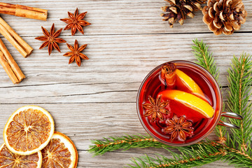 mulled wine glass and spices on wooden table