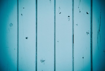 Blue paint texture wood panels with vignette background