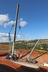 Crane laying concrete bridge beams