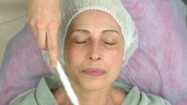 Face cryomassage, adult woman. Cosmetologist using liquid nitrogen. The science of rejuvenation.