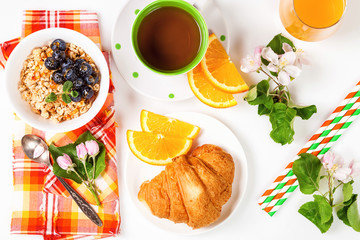  Muesli, blueberry, juice, tea and croissant