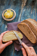 Spread fresh butter on whole wheat bread