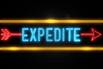 Expedite  - fluorescent Neon Sign on brickwall Front view