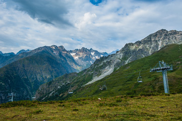 Mountain valley with snow peaks and clouds in Tetnuldi, Mestia, Georgia