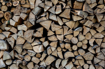 close up of firewood cut on logs and stacked in backyard