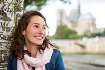 Obraz premium Portrait of a young tourist woman on Paris dock next to Notre Dame - Tourism and travel concept