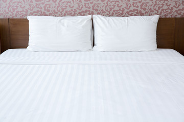 White pillows and bed in bedroom