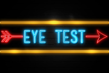 Eye Test  - fluorescent Neon Sign on brickwall Front view