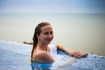 Woman in a swimming pool with Black sea view, Crimea, Russia