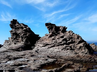 wild sea rocks view against blue sky. Portoscuso, Sardinia Italy