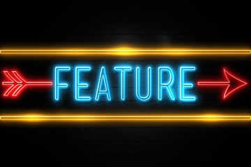 Fototapeta premium Feature - fluorescent Neon Sign on brickwall Front view