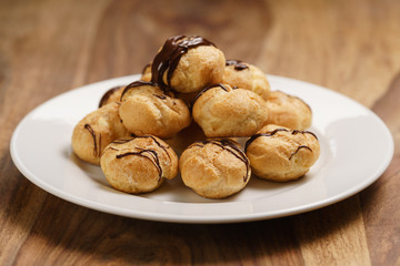 profiteroles with fine dark chocolate on plate
