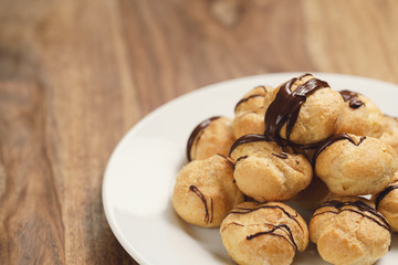 profiteroles with fine dark chocolate on plate