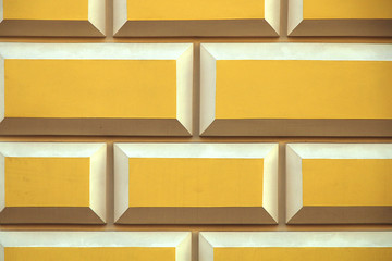 Wall of yellow blocks with white seams