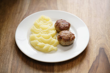 homemade cutlet with mashed potatoes on wood table