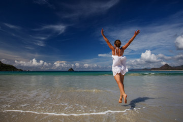 Young woman plays at the sea