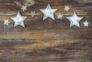 Fototapeta na wymiar Traditional Christmas decoration, star border on wooden background with copy space