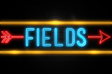 Fototapeta na wymiar Fields - fluorescent Neon Sign on brickwall Front view