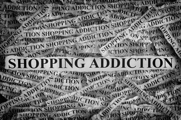 Shopping Addiction. Torn pieces of paper with the words Shopping Addiction