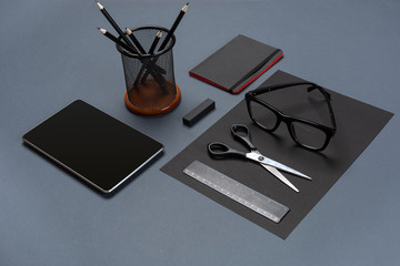 Set of black office stationery on a gray background, flat lay