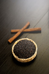 sesame and Cinnamon on black wooden background