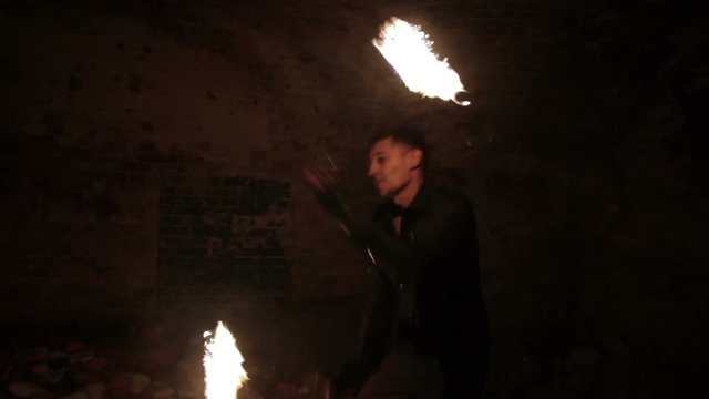 An actor shows fire show in the old German fort.