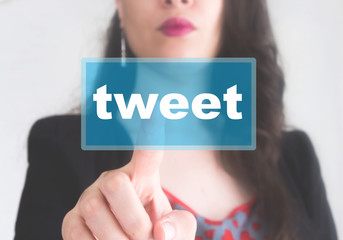 Businesswomen holding tweet button 