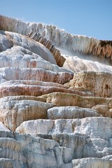 Fototapeta na wymiar Travertine terraces created by centuries of mineral deposits form the Mammoth Hot springs' geology