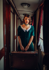 Obraz na płótnie Canvas Woman with suitcase in retro train, rich interior