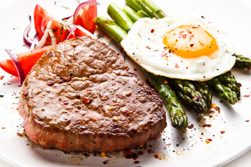 Grilled steak with asparagus and fried egg 
