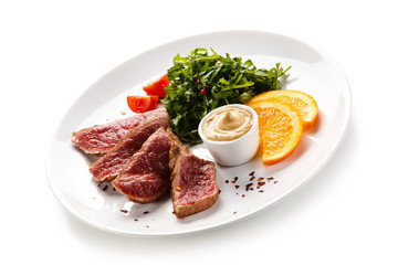 Fillet mignon - grilled beefsteaks with vegetables on white background 