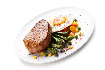 Grilled steak with asparagus and fried egg 