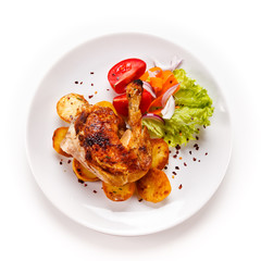 Roast chicken leg with chips on white background