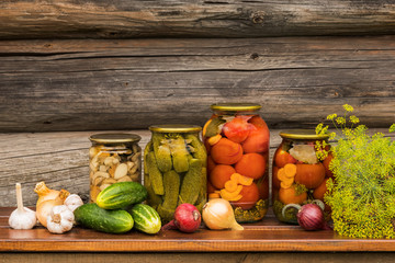 Fototapeta na wymiar Canned vegetables, tomatoes, cucumbers and mushrooms.