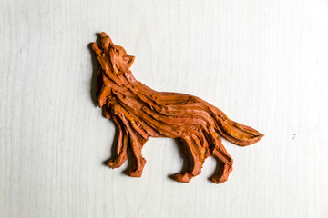 Handmade Figurine made of clay, plasticine on a wooden background