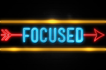 Focused  - fluorescent Neon Sign on brickwall Front view