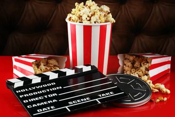 Popcorn in a striped box. Movie eating in theater