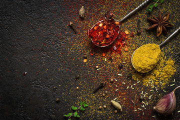 Spices food background. selection variety dry Whole and ground spices on a black background © colnihko