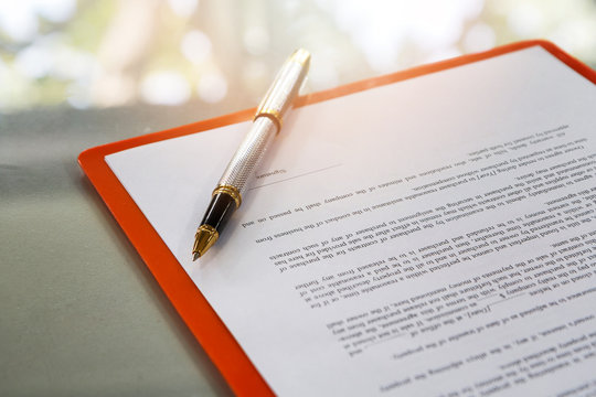 A pen on contract paper preparation for signing a contract.