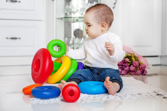 The baby is fond of toys at home. The concept of childhood development and lifestyle.