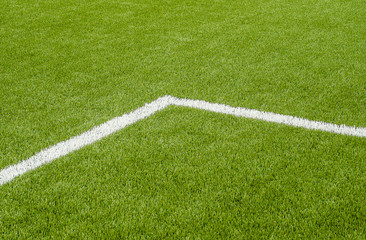 Obraz premium The white Line marking on the artificial green grass soccer field