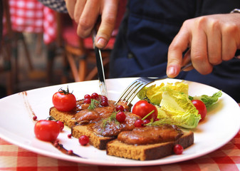 Man eating Foie gras in French restaurant