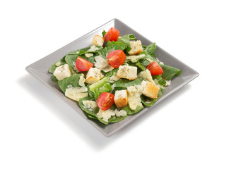 caesar salad in plate on white background