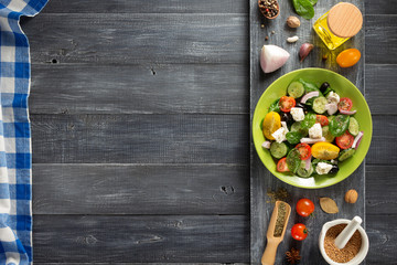 fresh greek salad in plate and ingredients